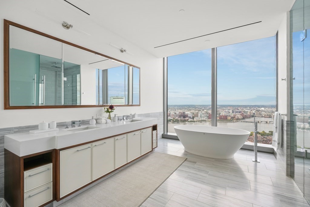 1 Dalton Street, Unit 5801/5802 Boston, MA 02115 - Photo 20 of 28 a bathroom with a double vanity sink and a large mirror