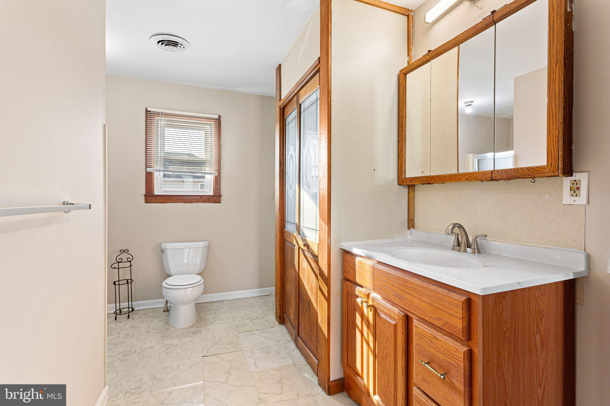 2623 Knights Road Bensalem, PA 19020 - Photo 40 of 50 a bathroom with a sink a toilet and a mirror
