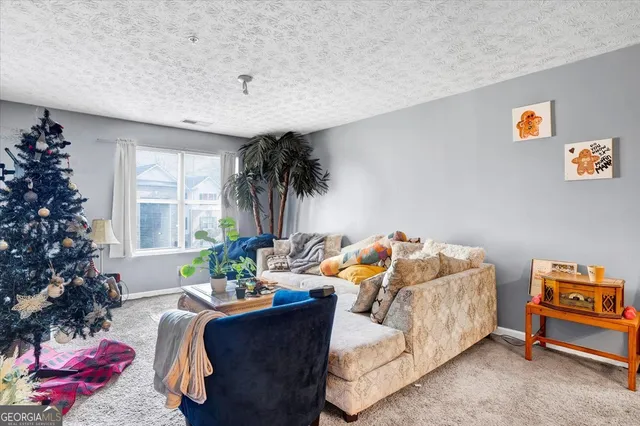 a living room with furniture and a potted plant