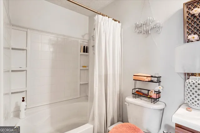 a white toilet sitting next to a bathroom sink
