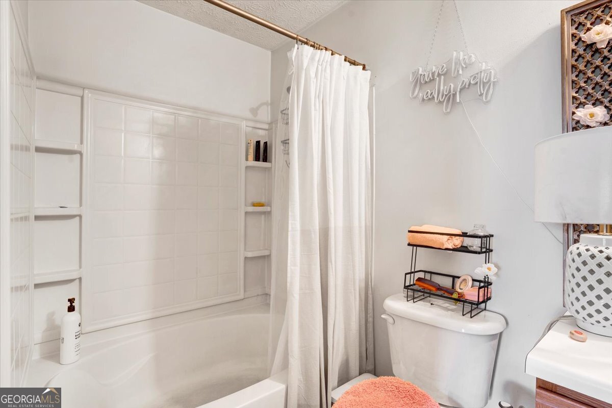 8301 Par 4 Way Lithonia, GA 30038 - Photo 3 of 4 a white toilet sitting next to a bathroom sink