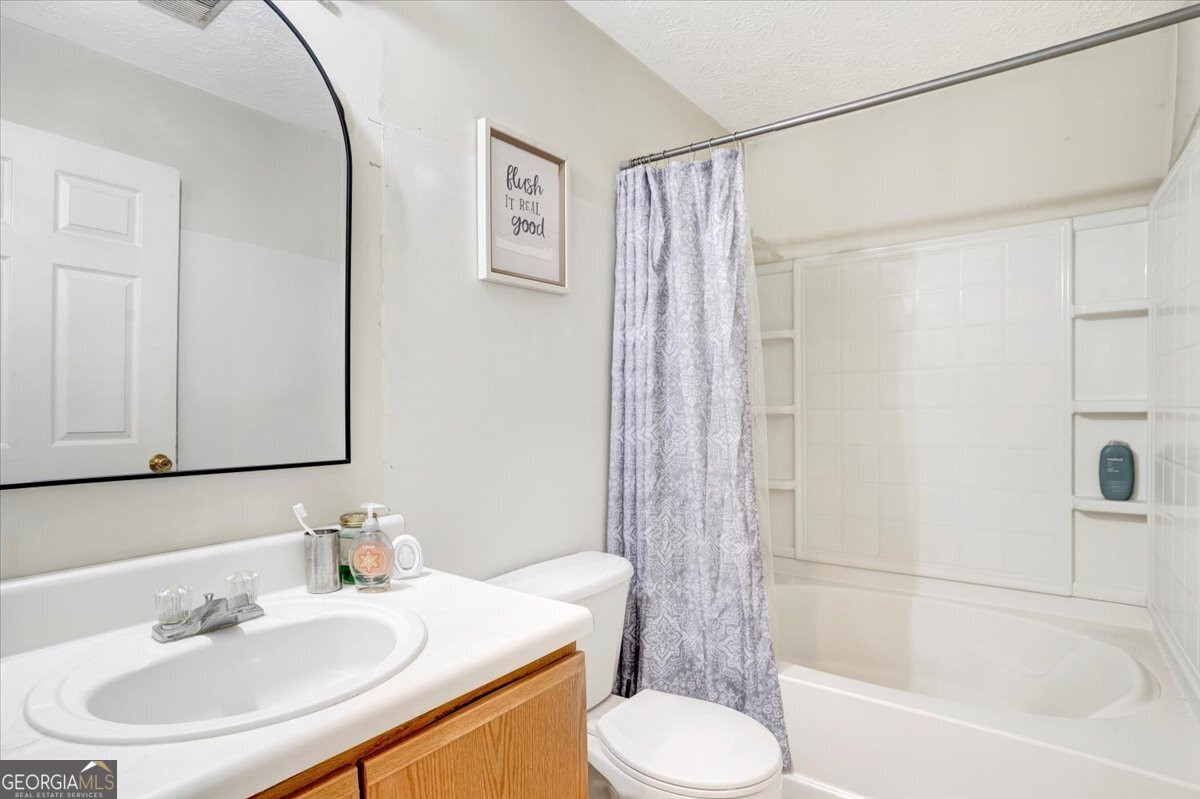 8301 Par 4 Way Lithonia, GA 30038 - Photo 4 of 4 a bathroom with a sink toilet and shower