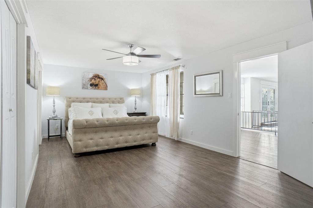 9501 Confederate Park Road Lakeside, TX 76135 - Photo 21 of 33 a bedroom with a bed and a chandelier