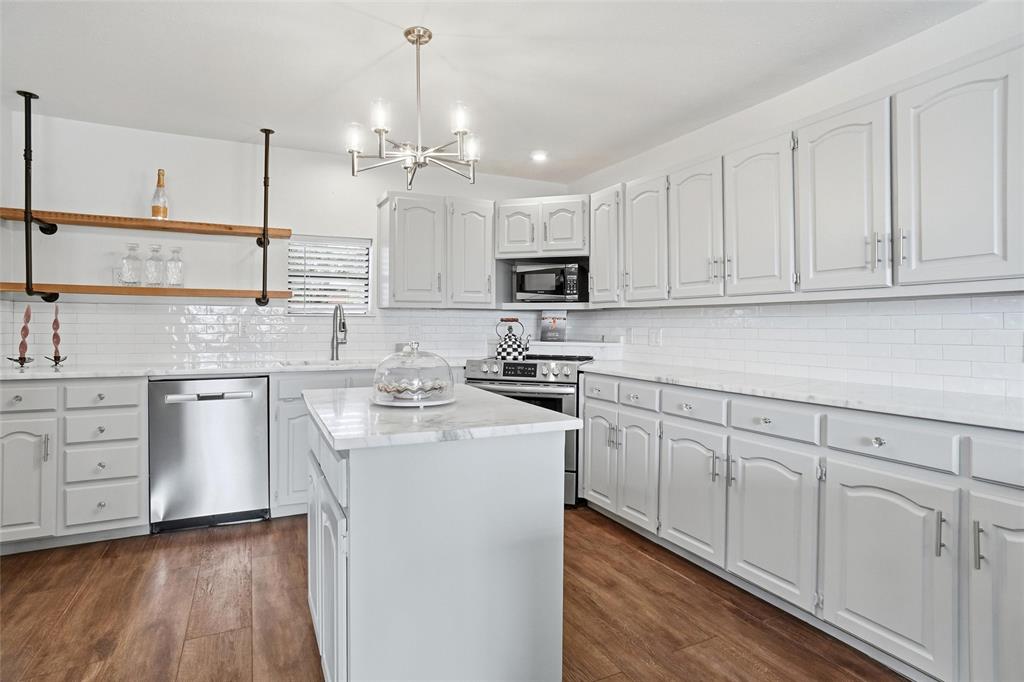 9501 Confederate Park Road Lakeside, TX 76135 - Photo 7 of 33 a kitchen with kitchen island white cabinets appliances and sink