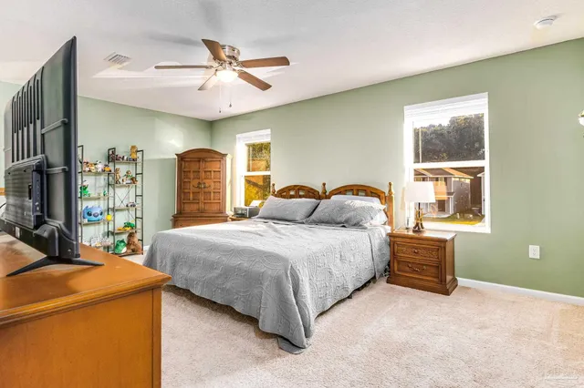 a bedroom with a bed and a dresser in it