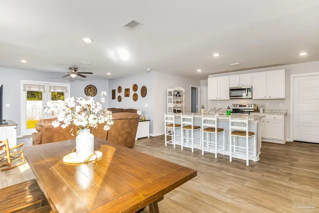 a view of a dining room with furniture and wooden floor