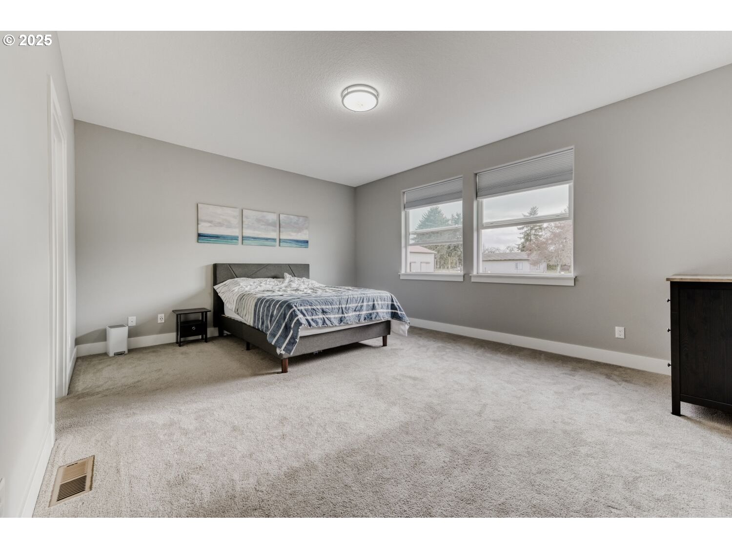 1561 Southwest Stringtown Road Forest Grove, OR 97116 - Photo 13 of 48 a spacious bedroom with a bed and a tv
