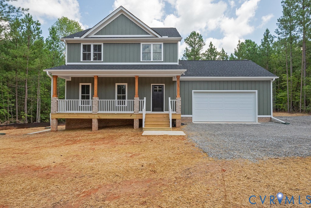 a view of a house with a yard and garage