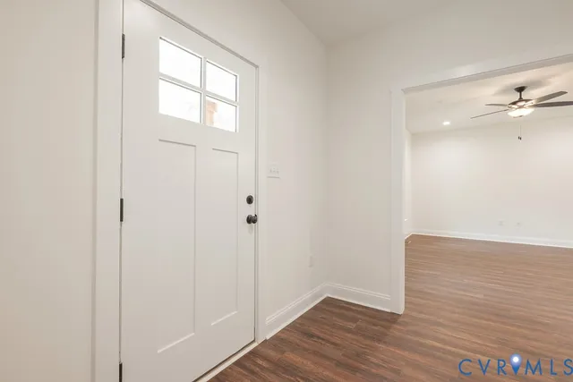 a view of an empty room with wooden floor