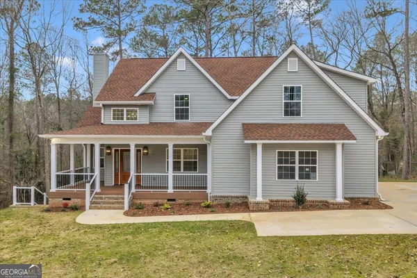 a front view of a house with a yard and porch