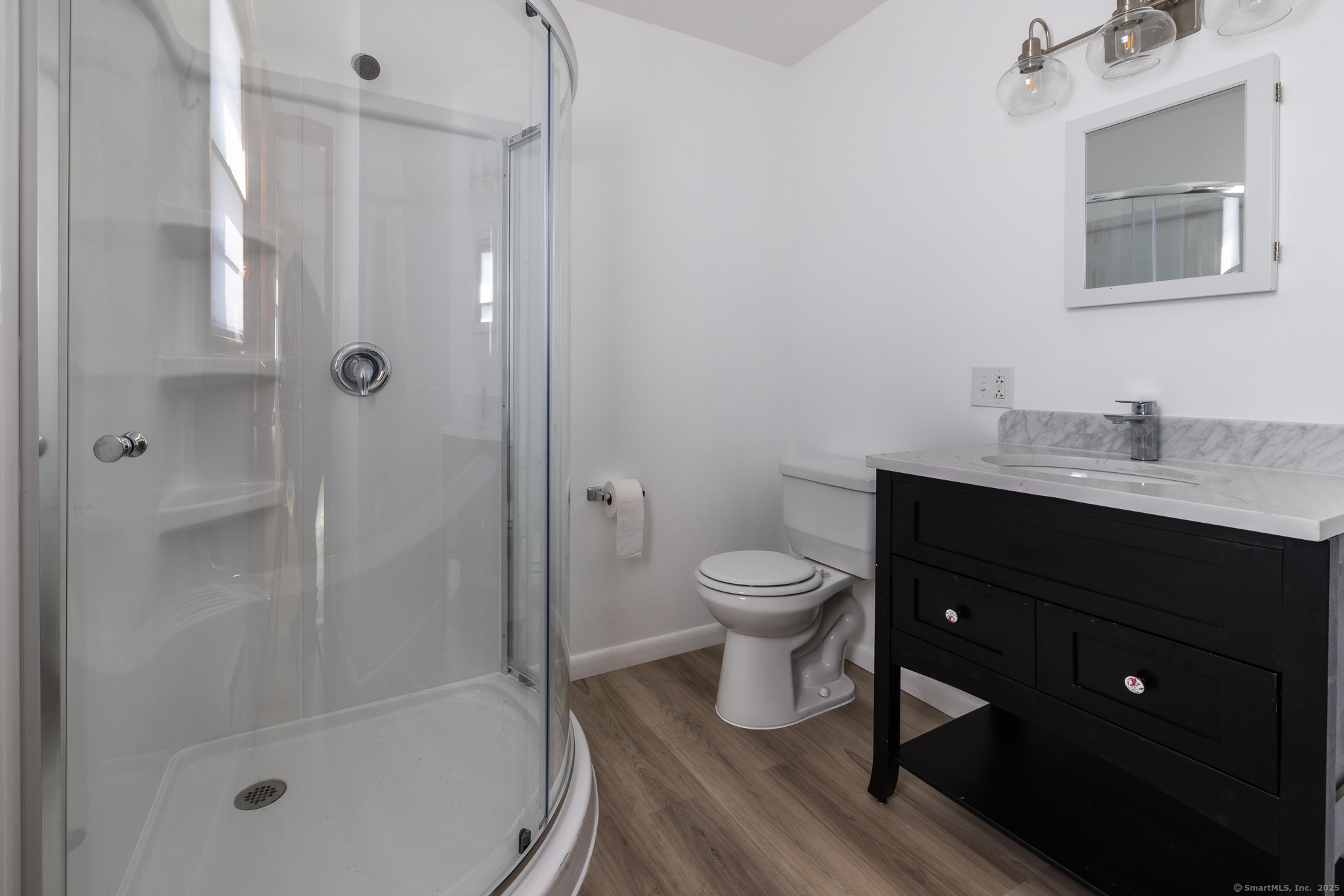 3845 Old Town Road Bridgeport, CT 06606 - Photo 16 of 27 a bathroom with a sink a toilet and shower