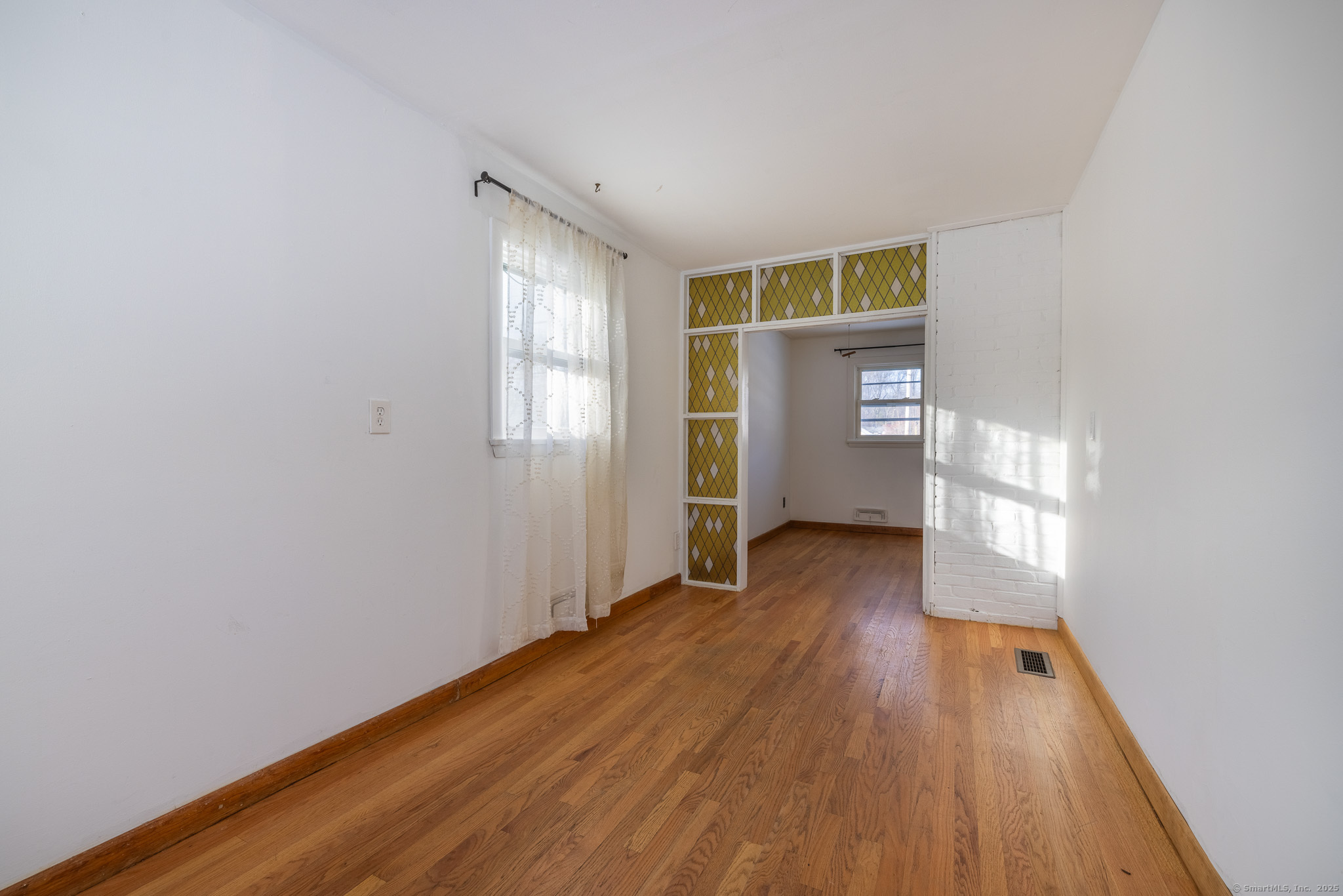 3845 Old Town Road Bridgeport, CT 06606 - Photo 20 of 27 an empty room with wooden floor and windows