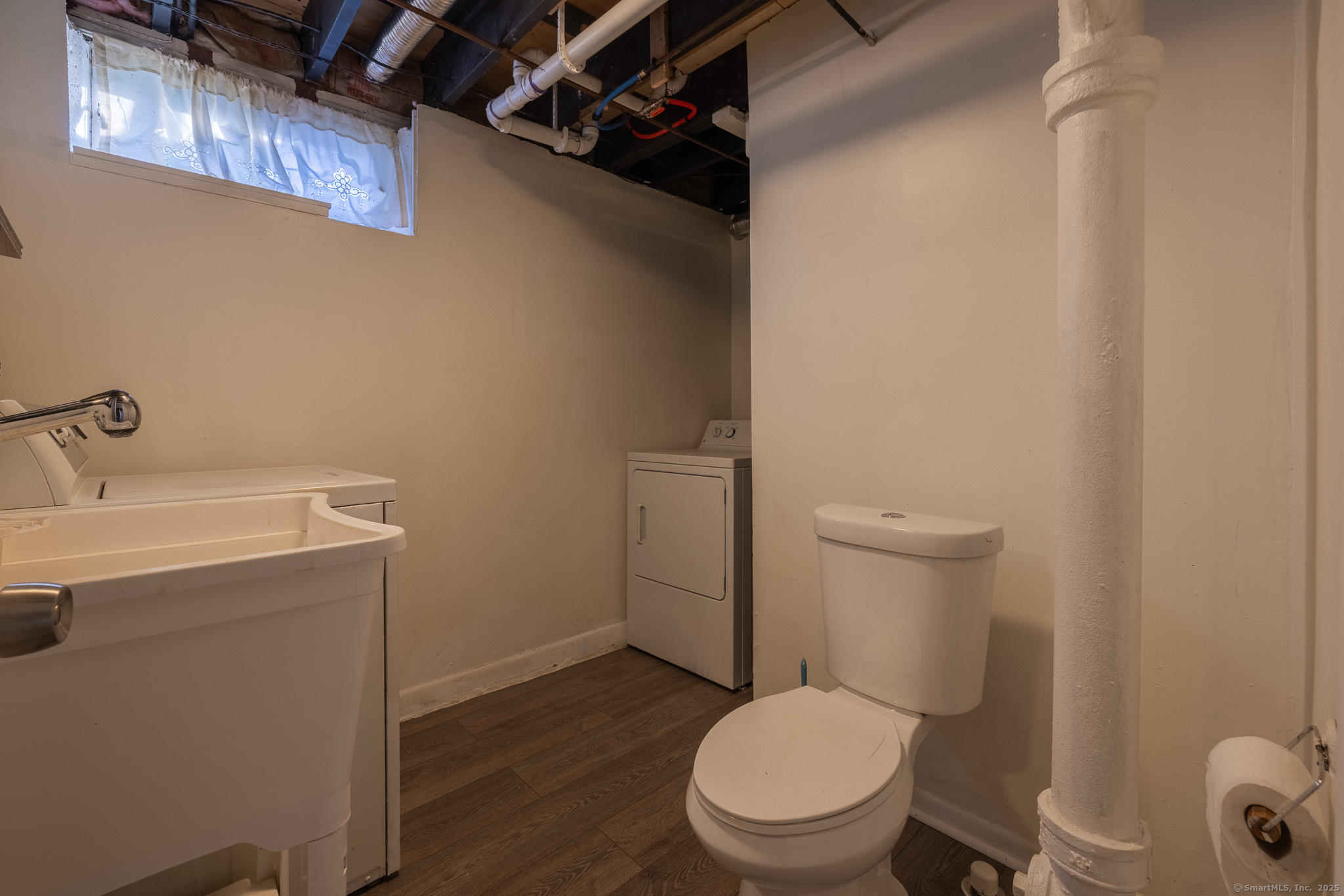 3845 Old Town Road Bridgeport, CT 06606 - Photo 25 of 27 a white toilet sitting next to a bathroom sink