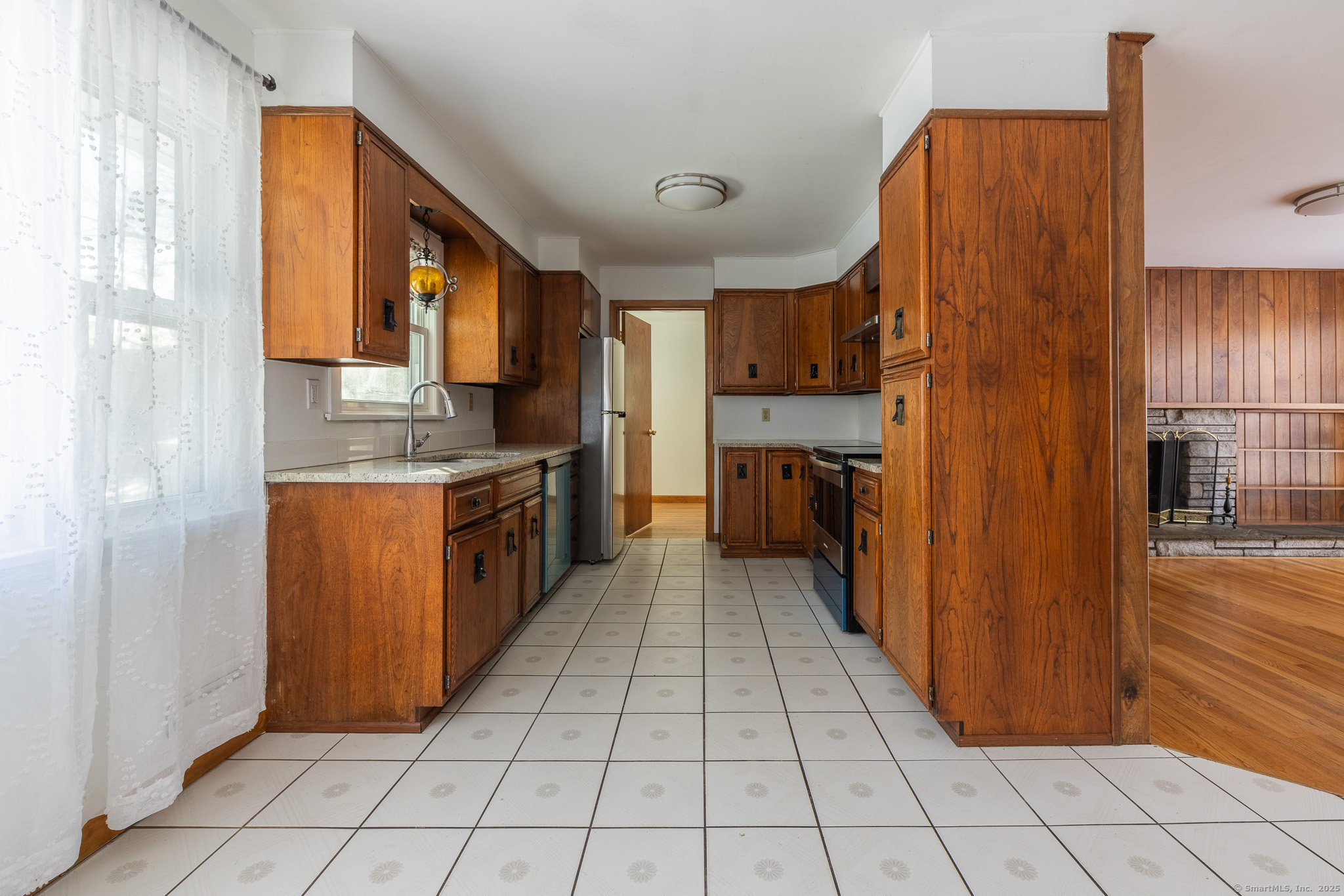 3845 Old Town Road Bridgeport, CT 06606 - Photo 7 of 27 a kitchen with stainless steel appliances granite countertop a refrigerator and a stove