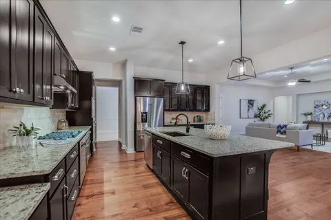 a kitchen with kitchen island granite countertop lots of counter top space