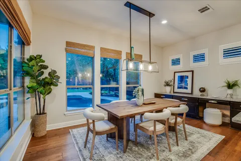 a view of a dining room with furniture window and wooden floor