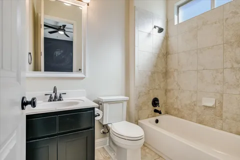 a bathroom with a sink a toilet and bathtub