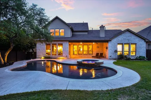 a view of a house with swimming pool and porch