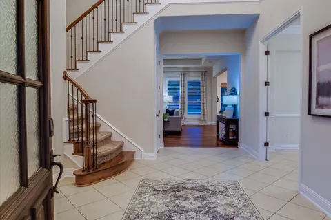 a view of a livingroom with furniture and stairs