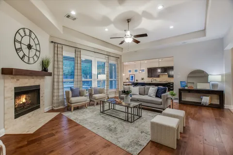 a living room with furniture a large window and a fireplace