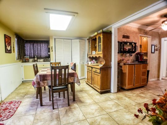 256 North Norma Street Ridgecrest, CA 93555 - Photo 13 of 35 a kitchen with a refrigerator and a table