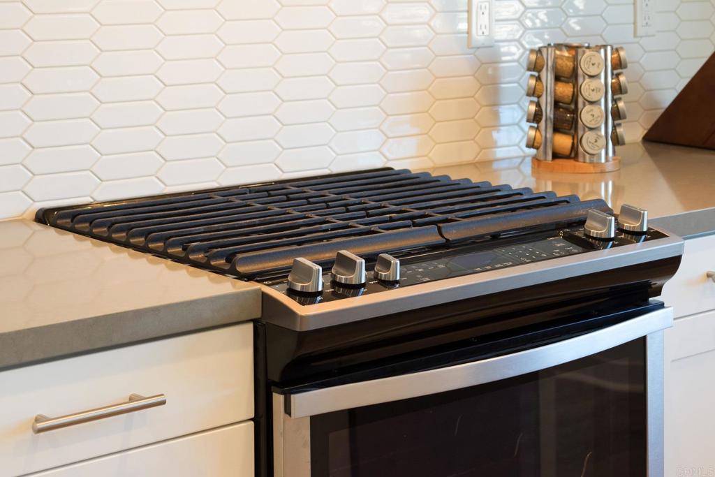 9056 Hightail Drive Santee, CA 92071 - Photo 11 of 73 a close up of a stove top oven sitting on a kitchen floor