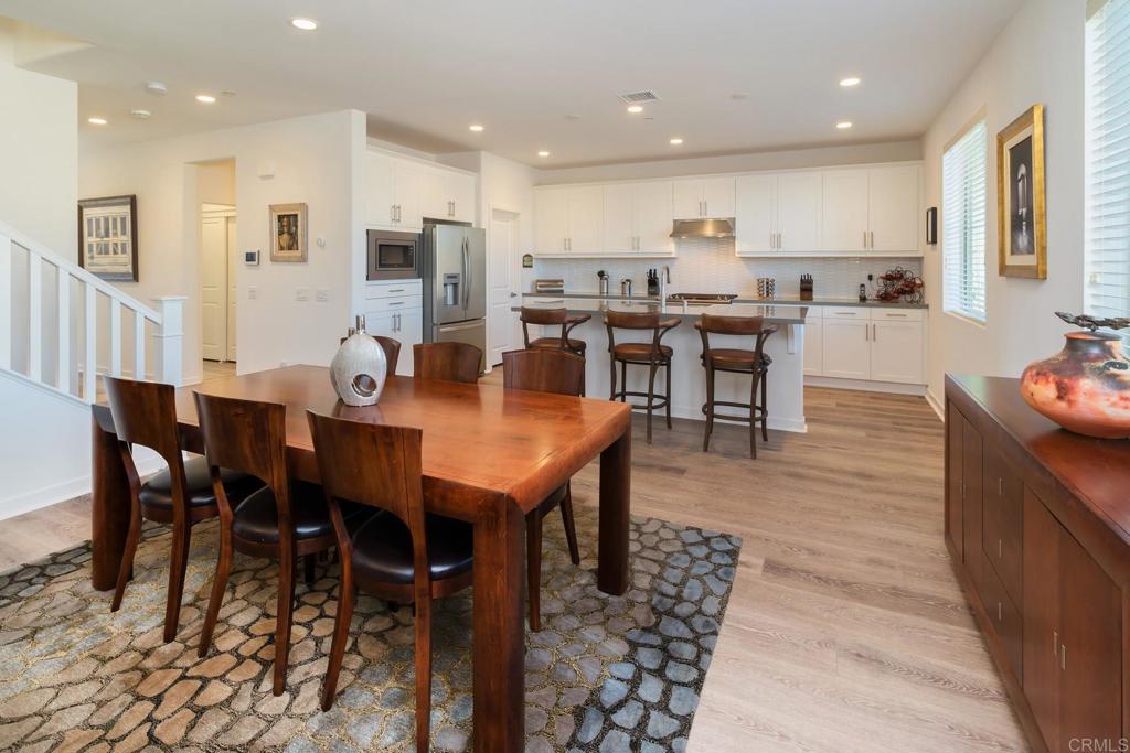 9056 Hightail Drive Santee, CA 92071 - Photo 14 of 73 a open kitchen with stainless steel appliances kitchen island granite countertop a dining table chairs and view kitchen