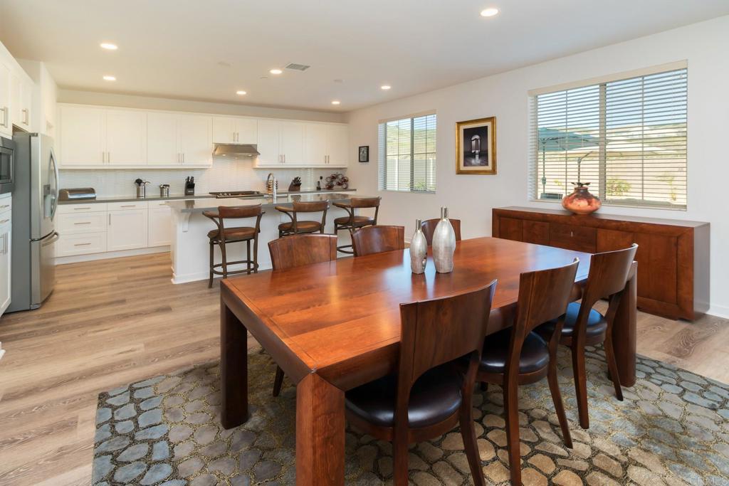 9056 Hightail Drive Santee, CA 92071 - Photo 19 of 73 a dining room with stainless steel appliances a table table and chairs