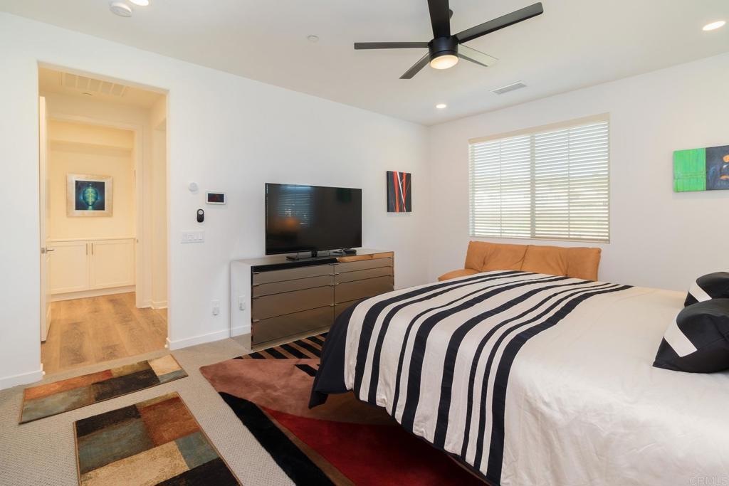 9056 Hightail Drive Santee, CA 92071 - Photo 22 of 73 a bedroom with a bed television on desk and a window