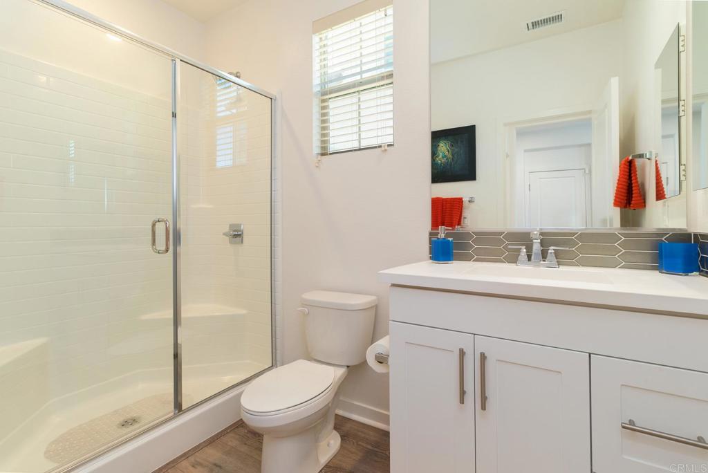 9056 Hightail Drive Santee, CA 92071 - Photo 26 of 73 a bathroom with a sink toilet vanity and shower