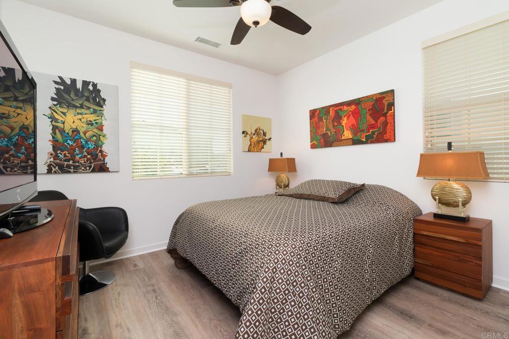 9056 Hightail Drive Santee, CA 92071 - Photo 27 of 73 a bedroom with a bed and wooden floor