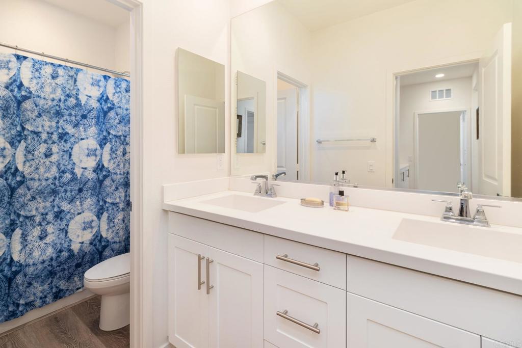 9056 Hightail Drive Santee, CA 92071 - Photo 32 of 73 a bathroom with a sink toilet and shower