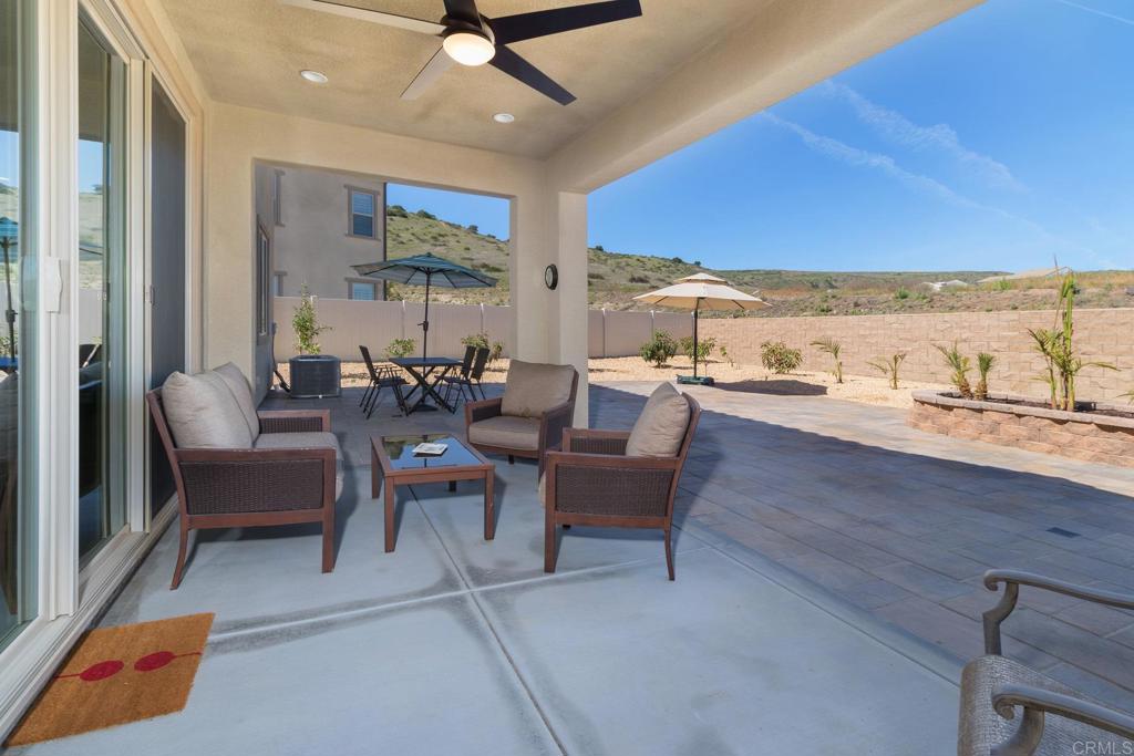 9056 Hightail Drive Santee, CA 92071 - Photo 34 of 73 a living room with furniture a rug and a floor to ceiling window