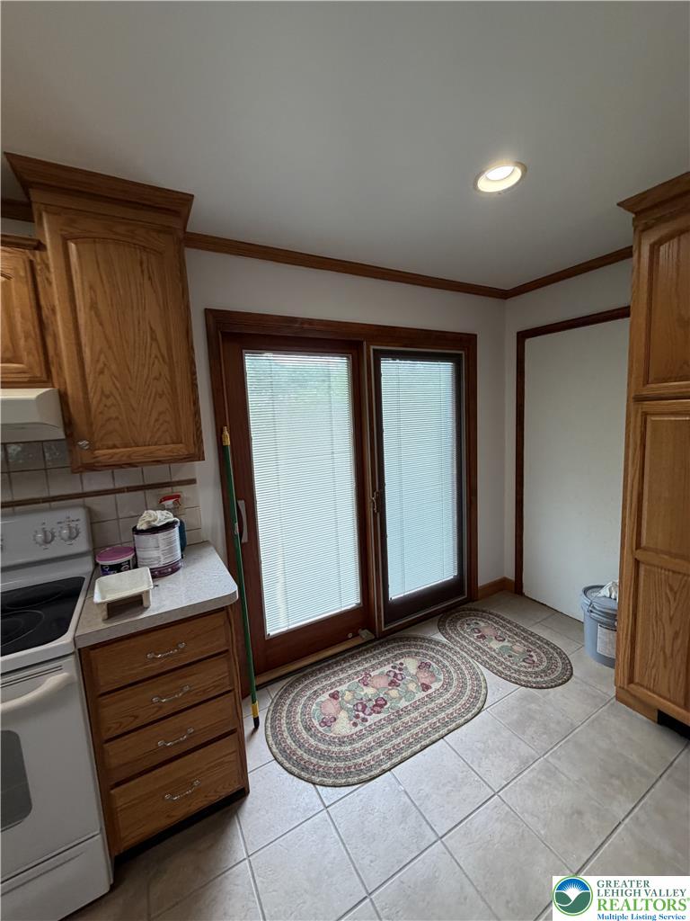 5391 Chapmans Road, Unit 2 Orefield, PA 18069 - Photo 22 of 22 Functional kitchen with ample cabinetry and easy access to outdoor space through glass sliding doors.
