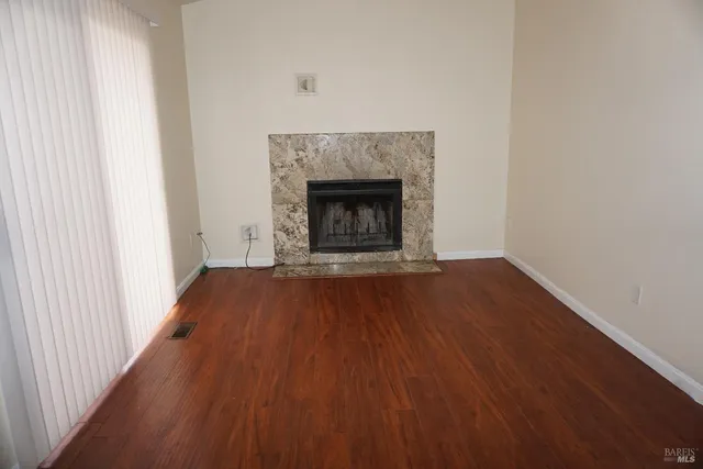 a view of an empty room and wooden floor