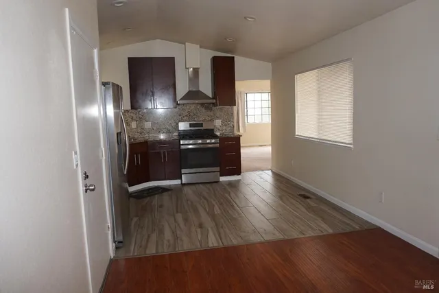 a kitchen with granite countertop stainless steel appliances and wooden cabinets