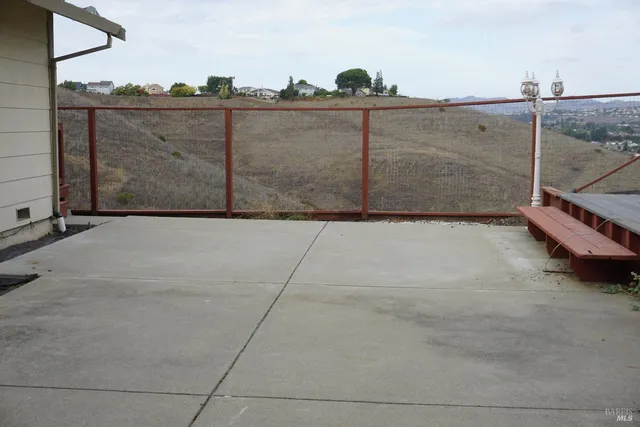 a view of backyard with wooden fence