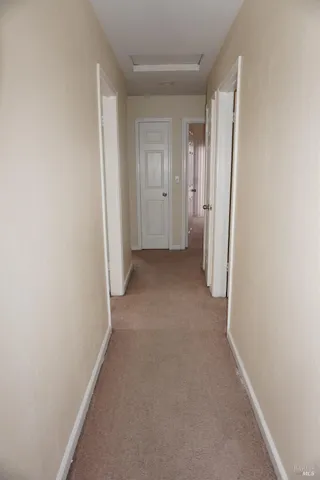 a view of hallway with closet and bathroom