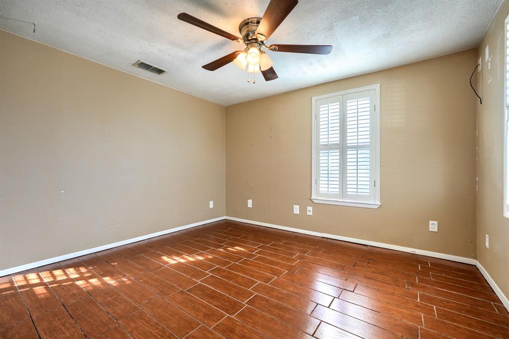 2112 Mangum Street Commerce, TX 75428 - Photo 12 of 19 a view of an empty room with window and a chandelier fan