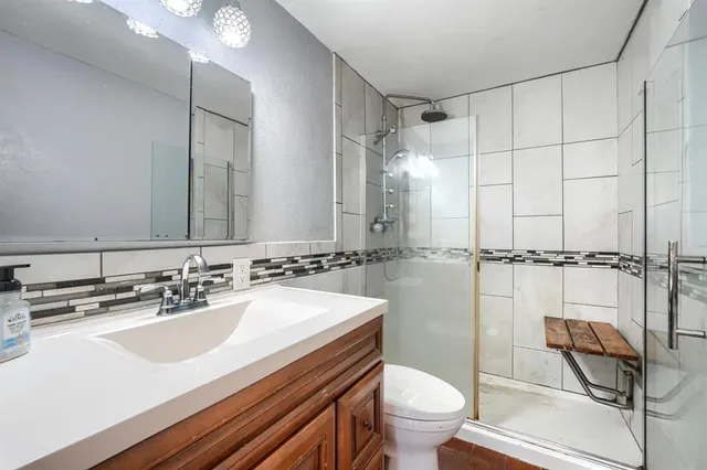 a bathroom with a sink toilet and shower