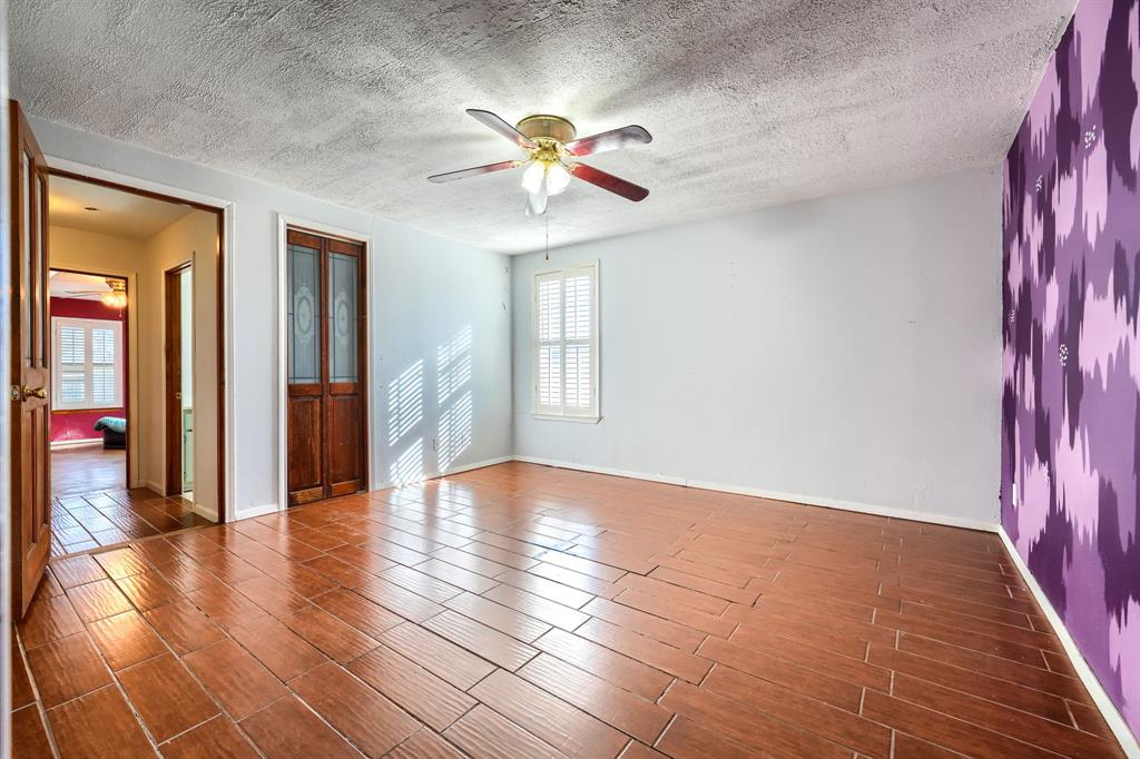 2112 Mangum Street Commerce, TX 75428 - Photo 14 of 19 a view of an empty room with window and wooden floor