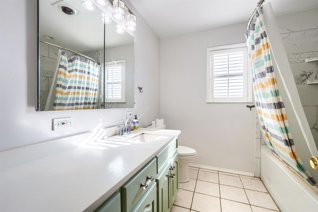 2112 Mangum Street Commerce, TX 75428 - Photo 16 of 19 a bathroom with a sink a vanity and a mirror
