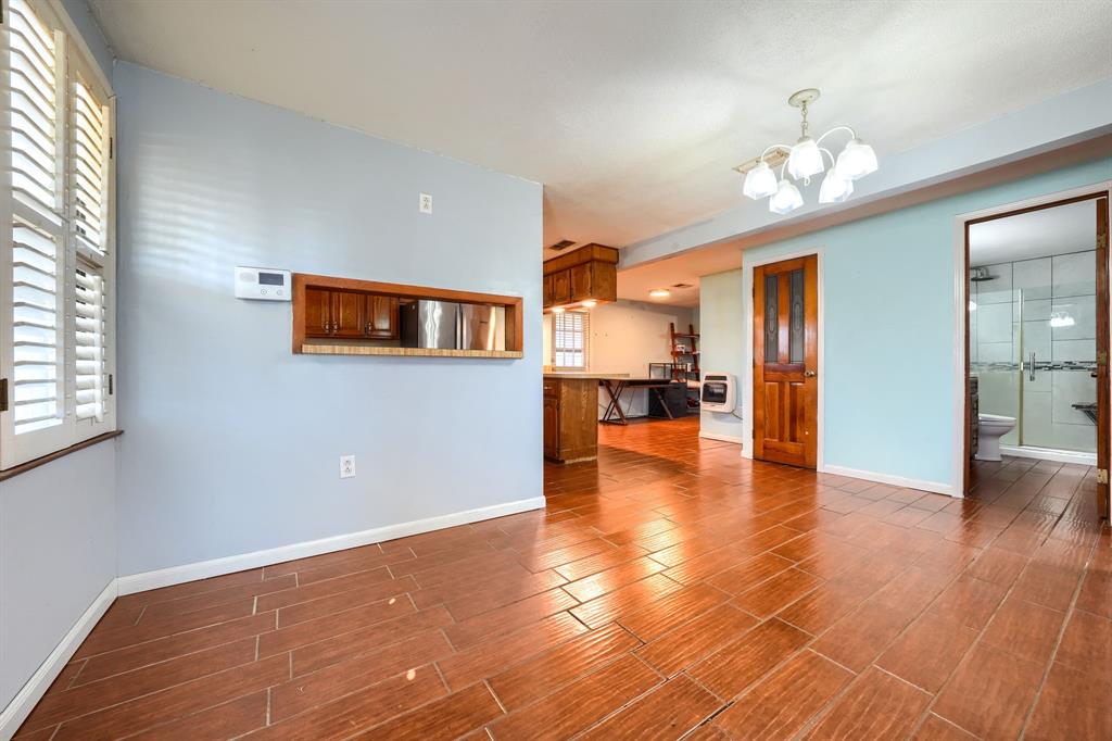 2112 Mangum Street Commerce, TX 75428 - Photo 4 of 19 a view of an empty room with kitchen and window