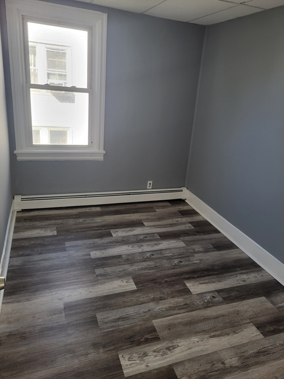 194 Buffinton Street, Unit 1 Fall River, MA 02721 - Photo 2 of 6 a view of wooden floor and windows in a room