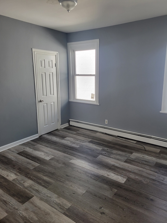 194 Buffinton Street, Unit 1 Fall River, MA 02721 - Photo 3 of 6 a view of a room with wooden floor and window
