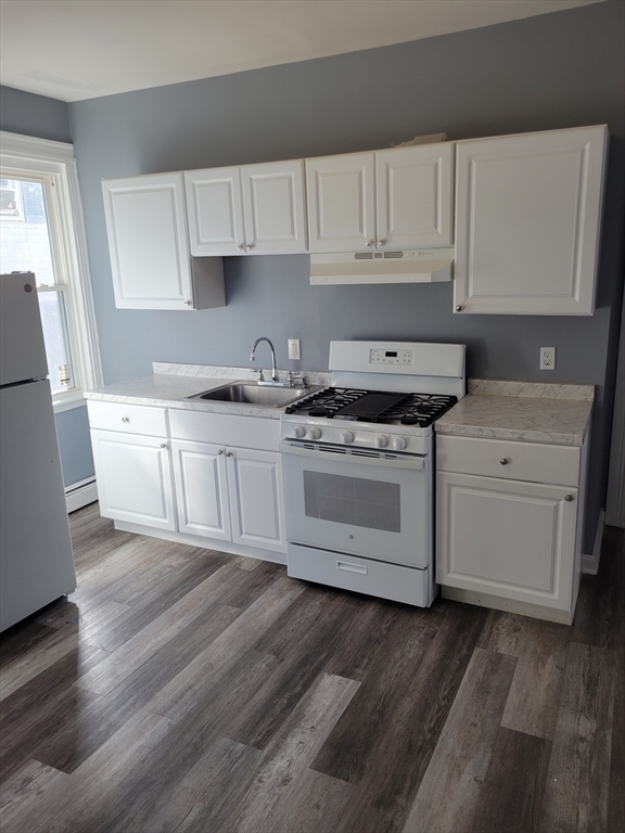 194 Buffinton Street, Unit 1 Fall River, MA 02721 - Photo 6 of 6 a kitchen with granite countertop white cabinets and white appliances