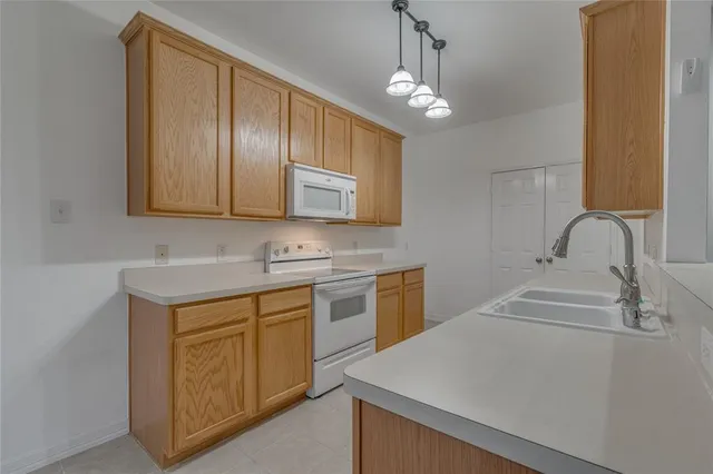 a kitchen with a sink cabinets and window