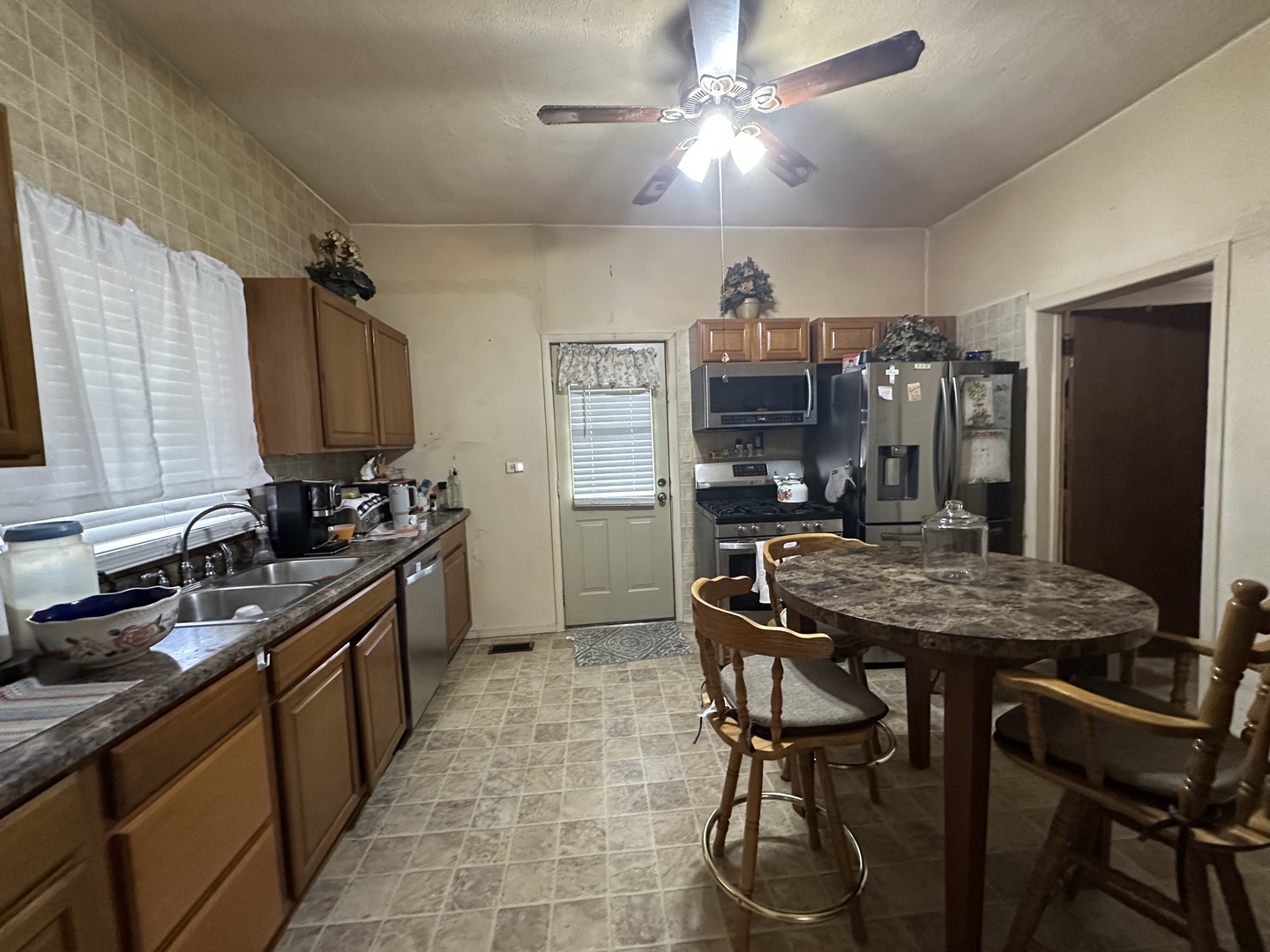 410 South Walnut Street Sesser, IL 62884 - Photo 19 of 22 a kitchen with stainless steel appliances granite countertop a sink a stove and a refrigerator