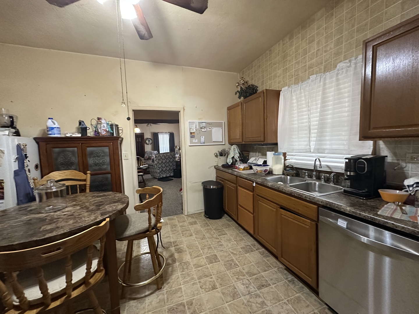 410 South Walnut Street Sesser, IL 62884 - Photo 20 of 22 a kitchen with stainless steel appliances granite countertop a stove top oven a sink dishwasher a dining table and chairs with wooden floor