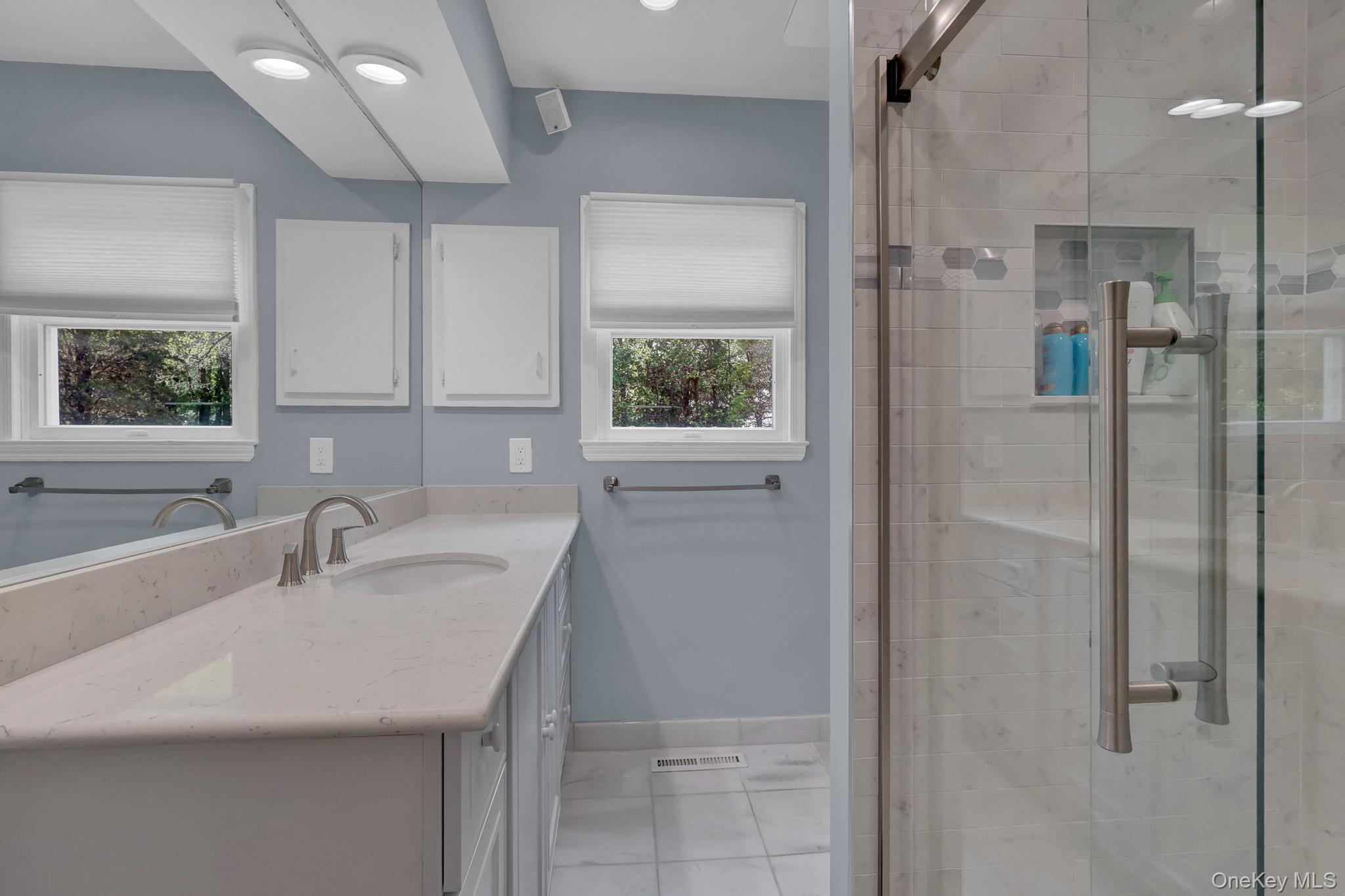 15 Stillwater Road Nissequogue, NY 11780 - Photo 21 of 43 2nd primary Bathroom featuring a dual-sink vanity with a light-toned countertop, brushed nickel fixtures, and ample cabinetry